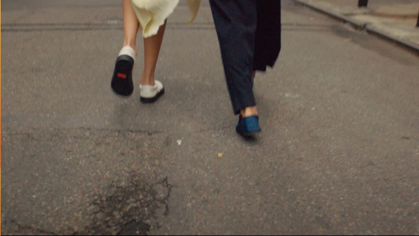 a man and a woman walking down the street