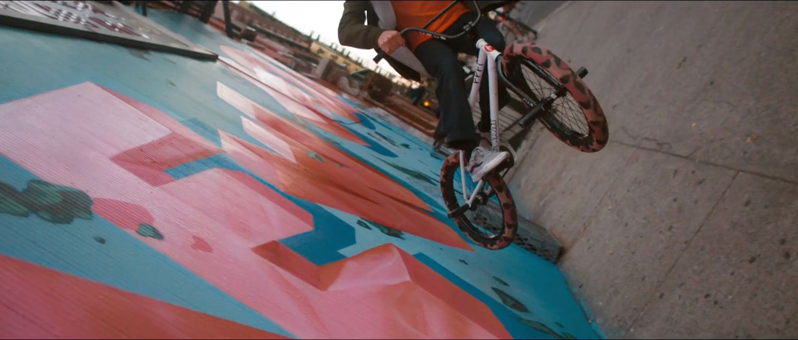 a person riding a bike down a street