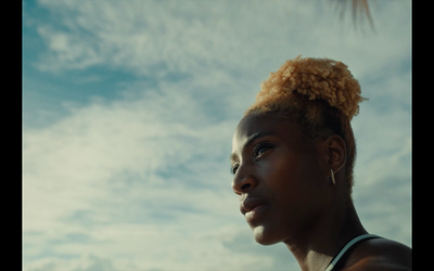 a woman with an afro is staring into the distance