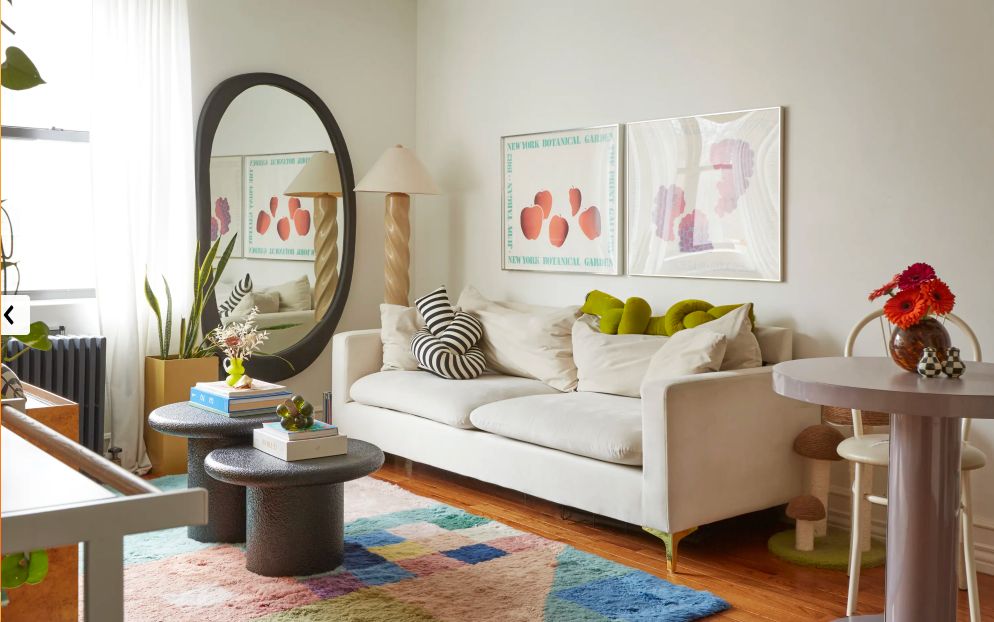 a living room filled with furniture and a mirror