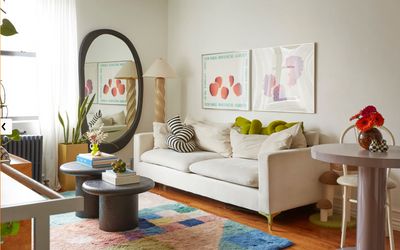 a living room filled with furniture and a mirror