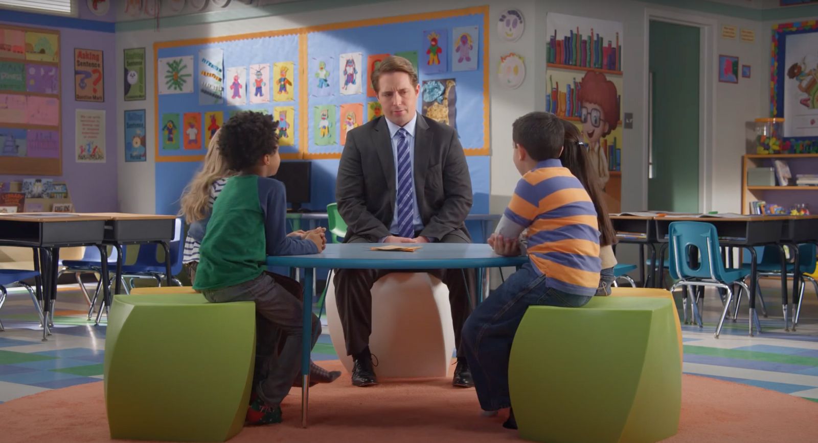 a man sitting at a table with two children