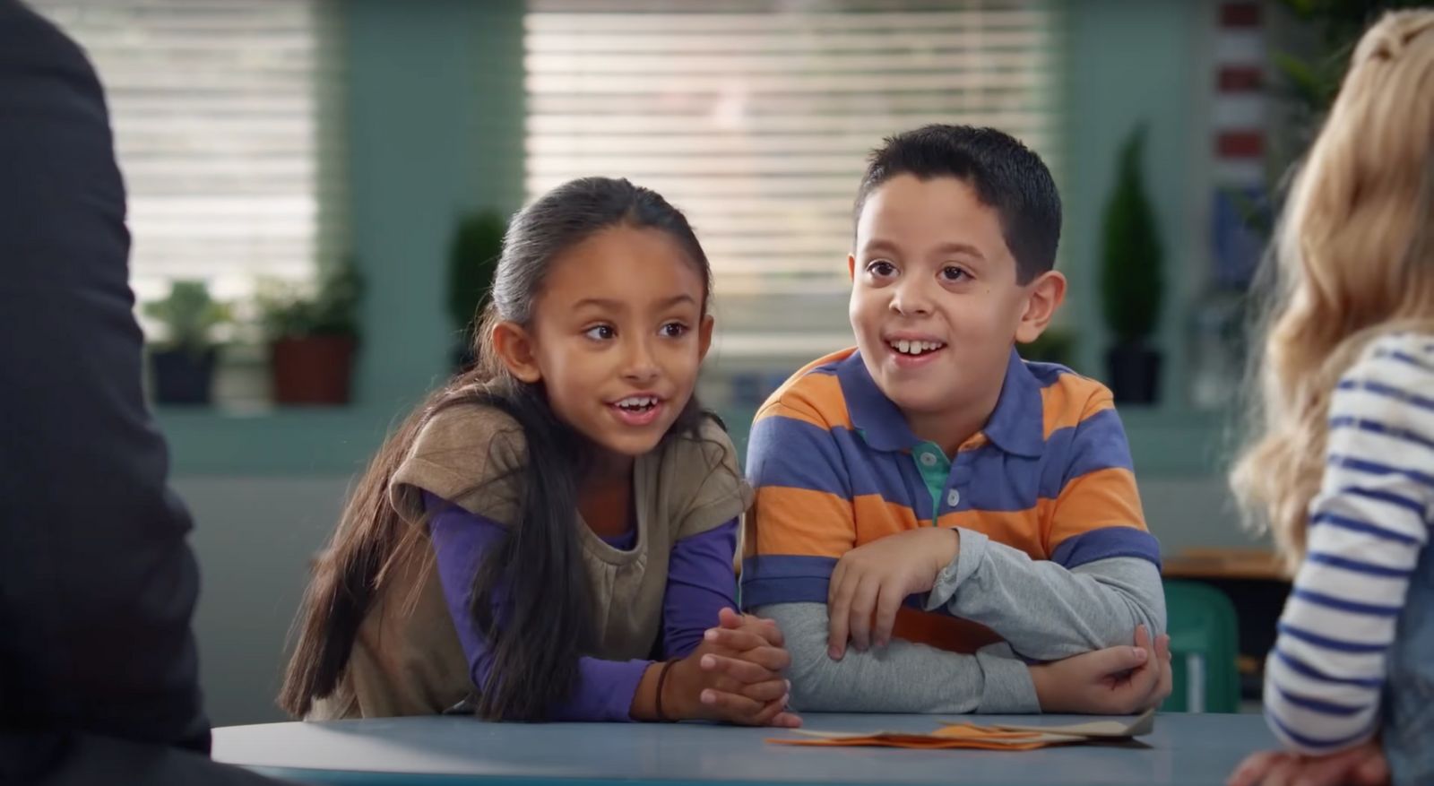 a couple of kids sitting at a table