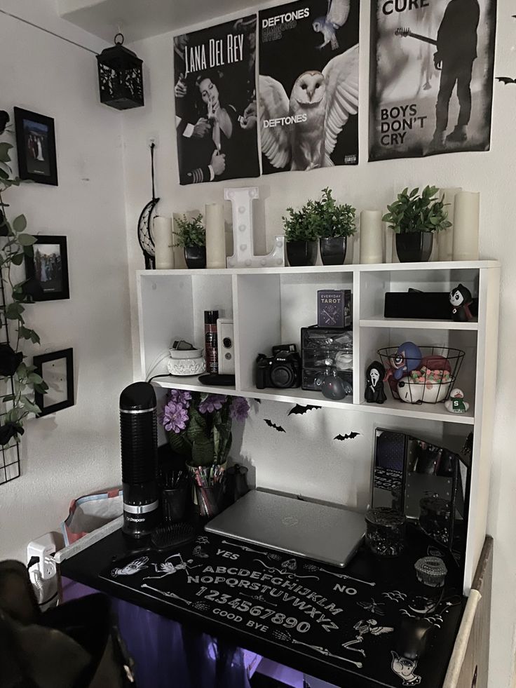 a black and white desk and some pictures on the wall