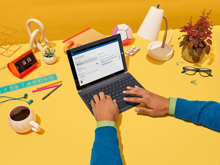 a person typing on a laptop on a table