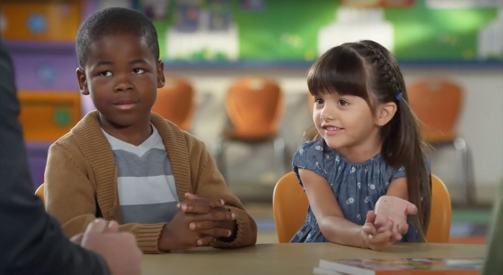 a group of children sitting at a table