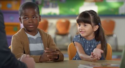 a group of children sitting at a table