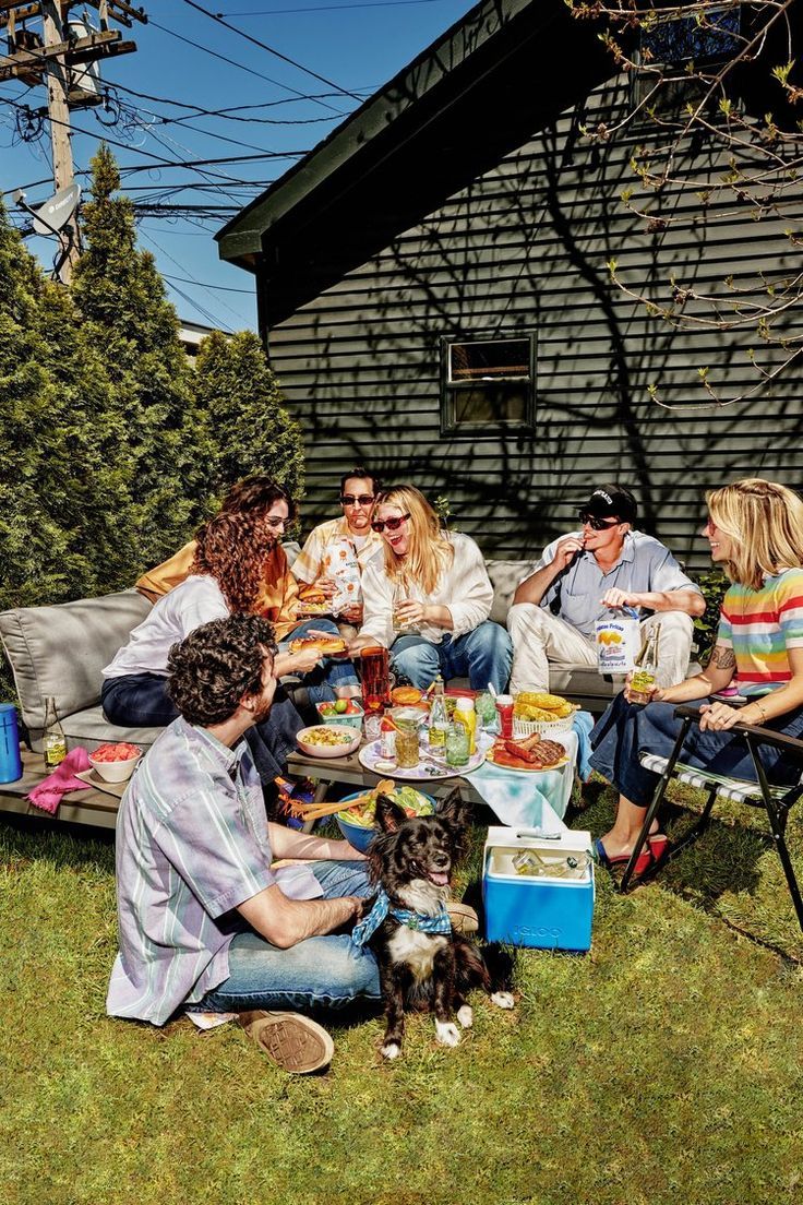 a group of people sitting around a table outside