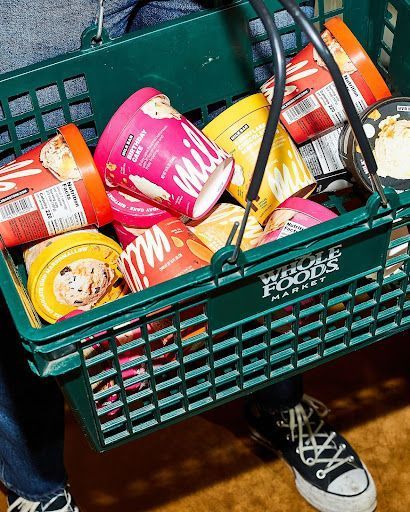 a person holding a basket full of food