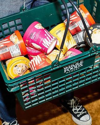 a person holding a basket full of food