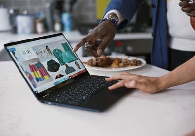 a man and a woman using a laptop computer