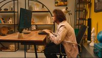 a man sitting at a desk using a computer