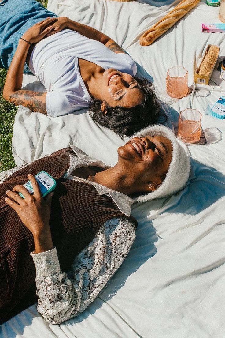 a couple of people laying on top of a blanket