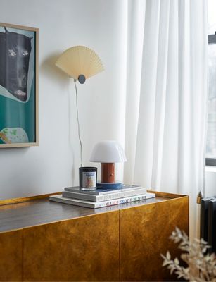 a table with a lamp and books on it