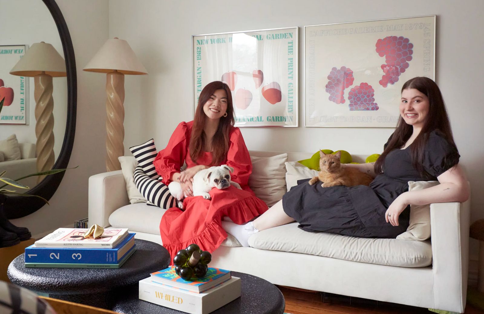 two women sitting on a couch with a dog