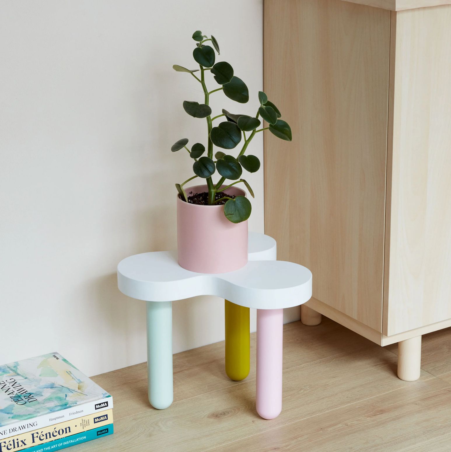 a white table with a potted plant on top of it