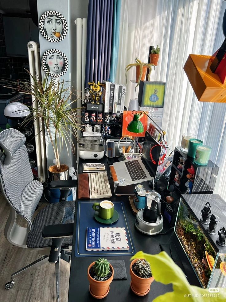 a desk with a laptop and various plants on it