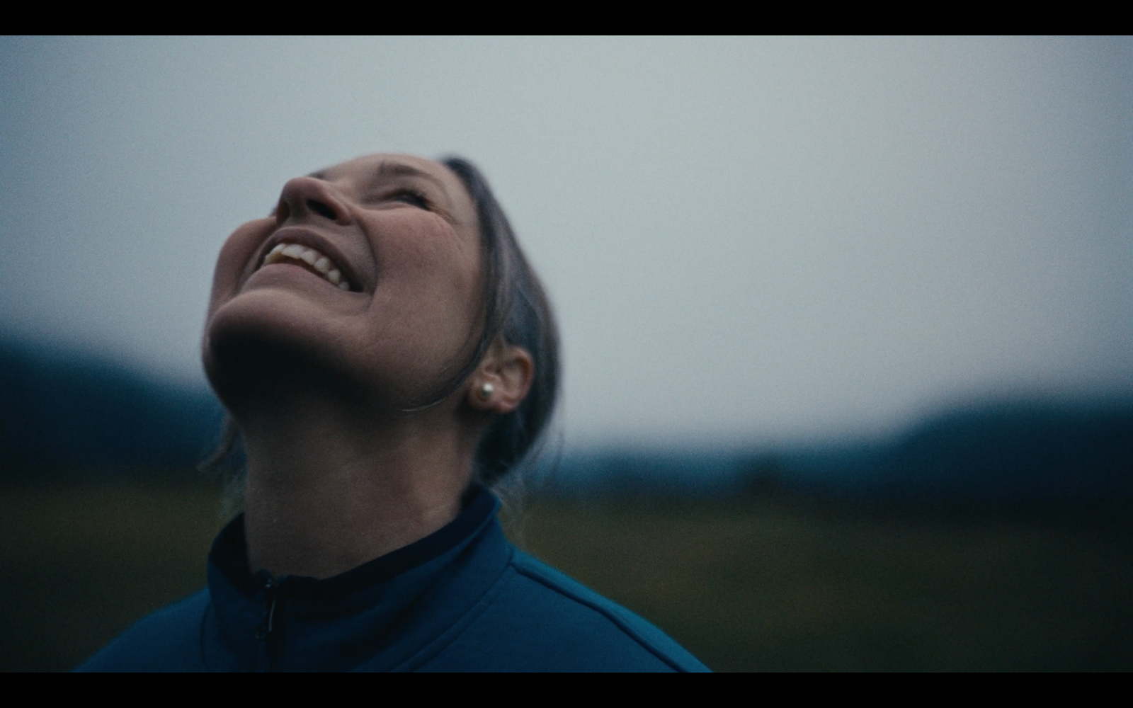 a woman looking up at the sky with her eyes closed