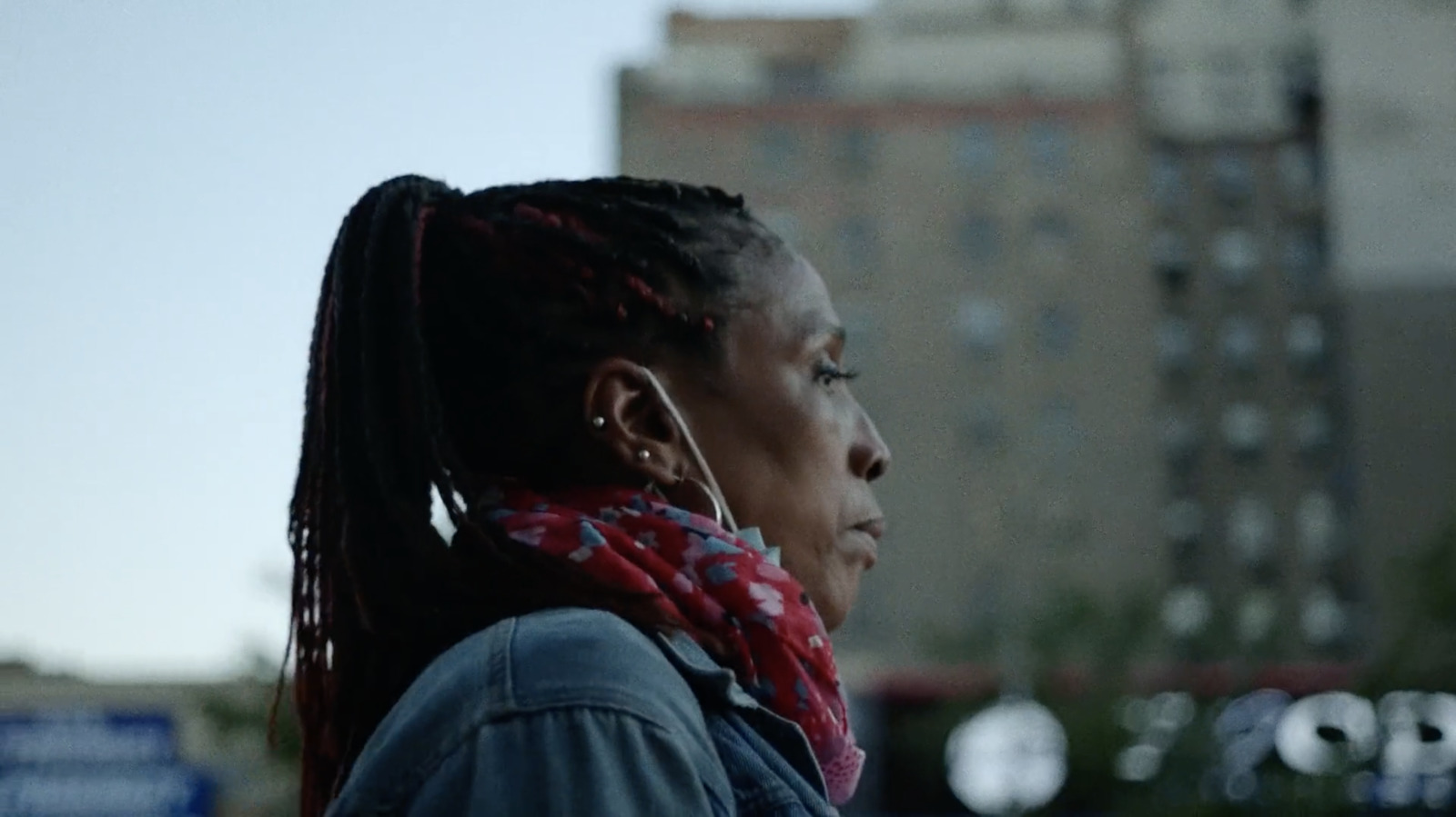 a woman with dreadlocks standing in the street