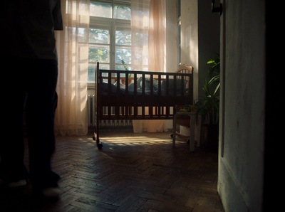 a person standing next to a crib in a room