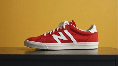 a pair of red and white shoes sitting on top of a table