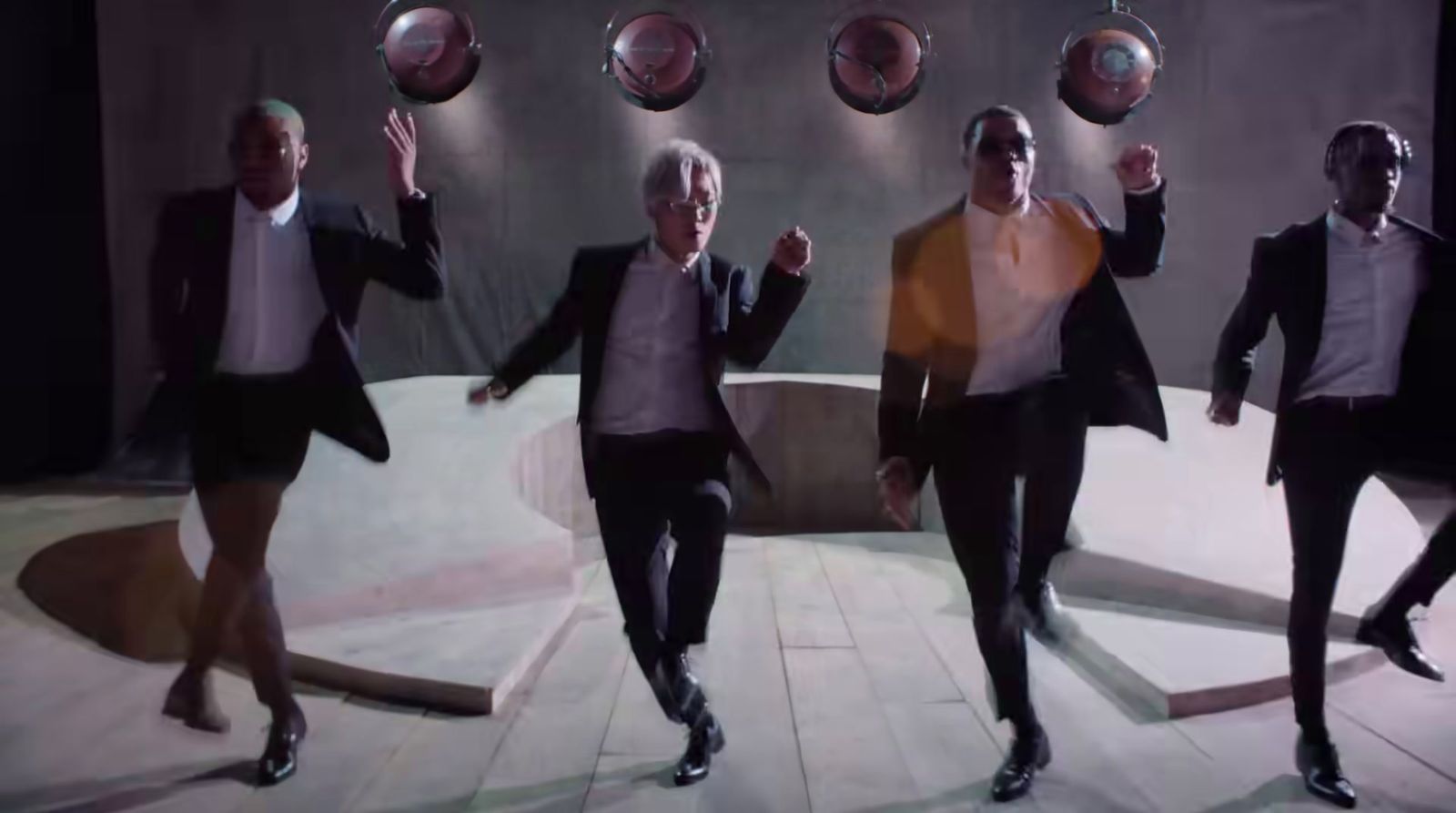 a group of men in suits and ties dancing