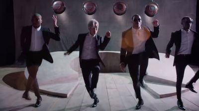 a group of men in suits and ties dancing