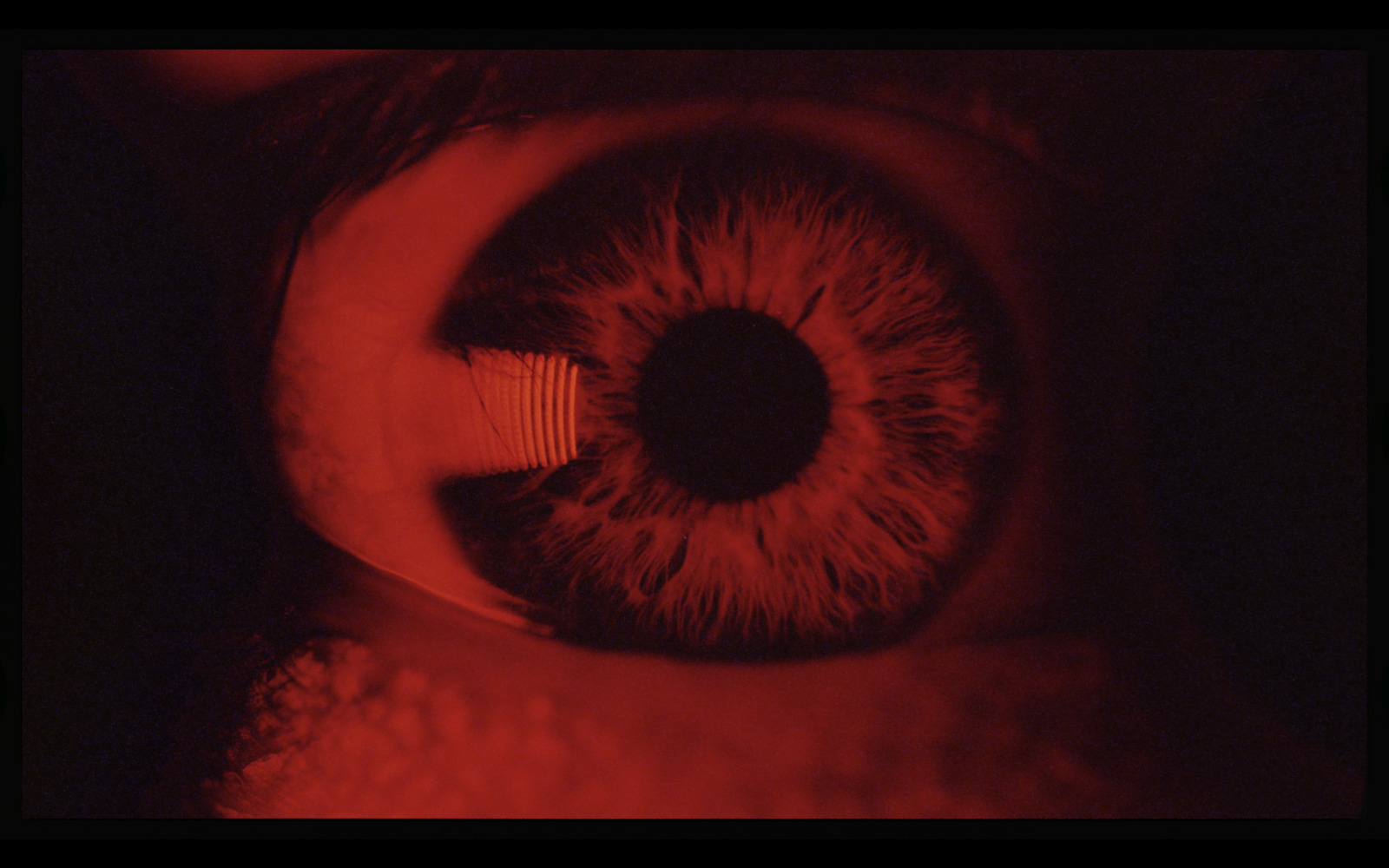 a close up of an eye with red light