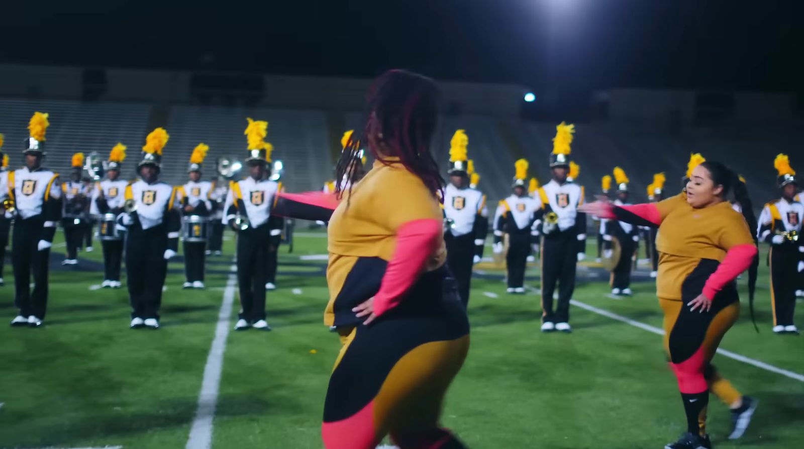 a group of people on a field with a band