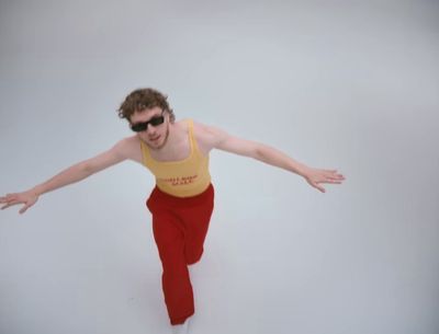 a man in a tank top and red pants