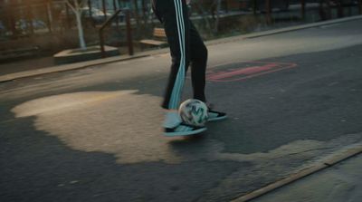 a person riding a skateboard down a street