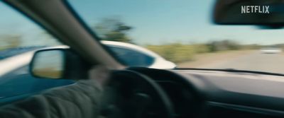 a man driving a car on a highway