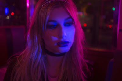 a woman wearing a tiara in a dark room