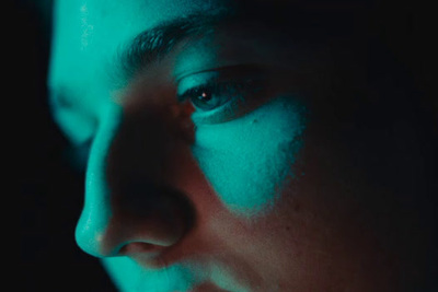 a close up of a person's face in the dark