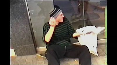 a man sitting on a toilet talking on a cell phone