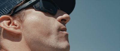 a close up of a man wearing sunglasses and a hat