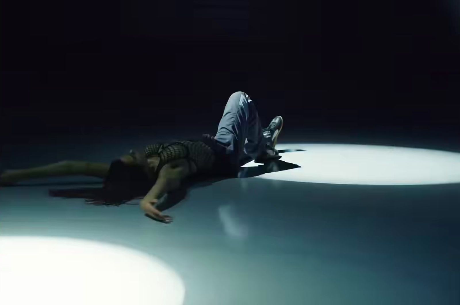 a person laying on the ground in the dark