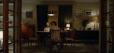 a woman sitting at a table in a living room