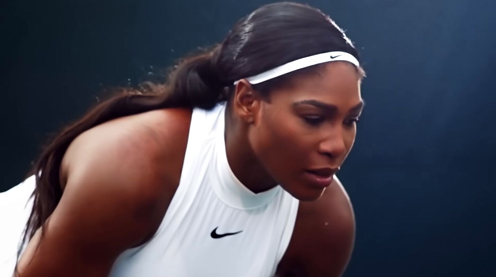 a woman holding a tennis racquet on a tennis court