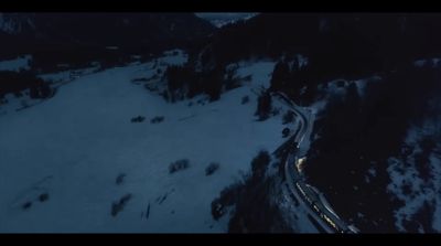 an aerial view of a road in the snow