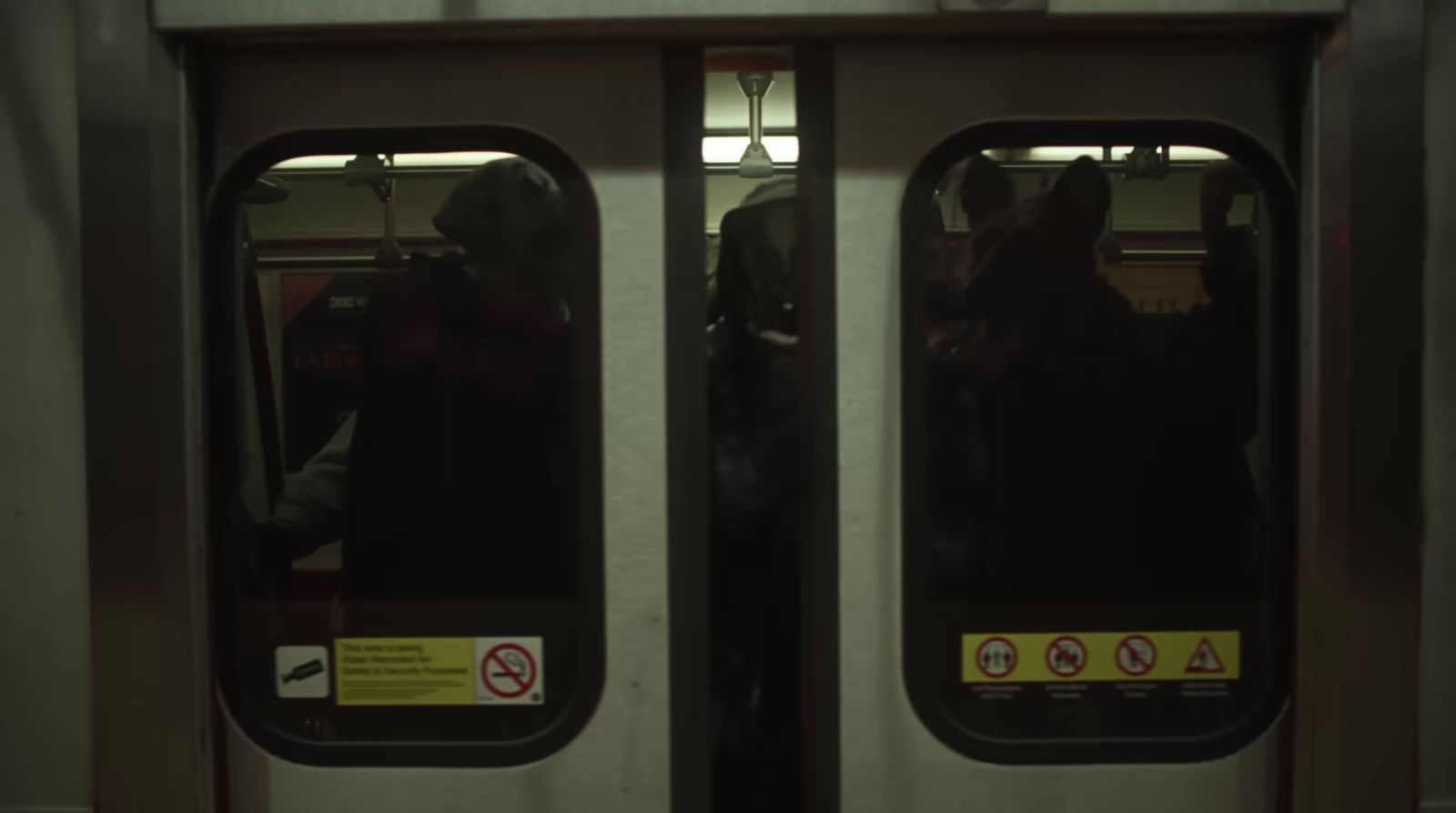 a subway train door with a person standing in it