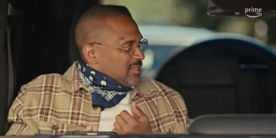 a bald man wearing a scarf in a car