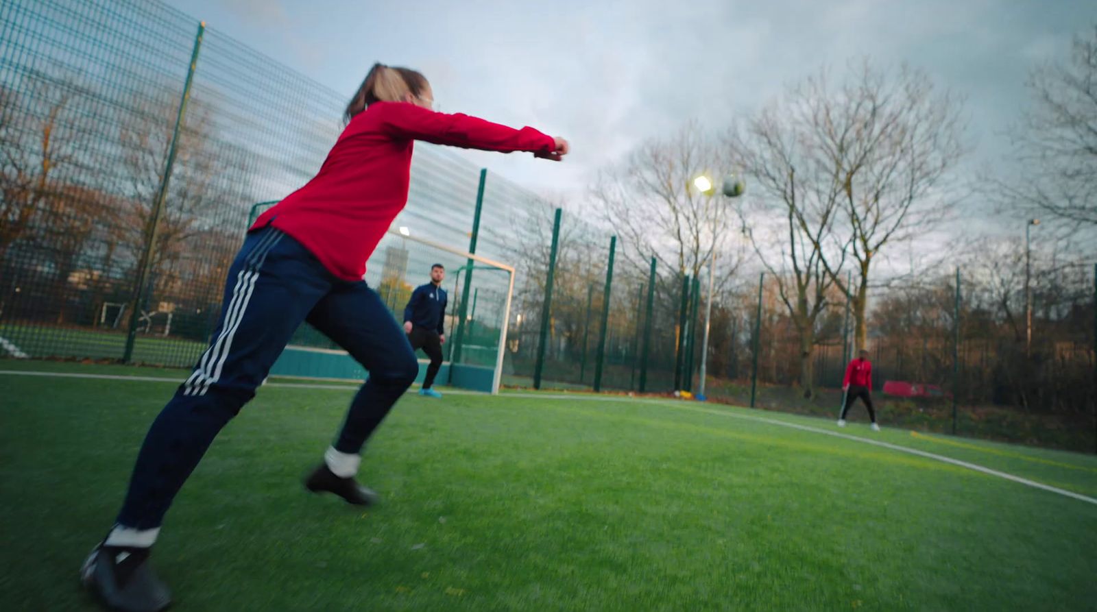 a man and a woman playing frisbee on a field