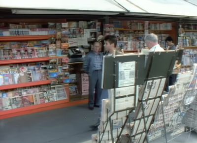 a man standing in front of a book store