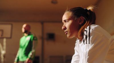 a man and a woman playing a game of basketball