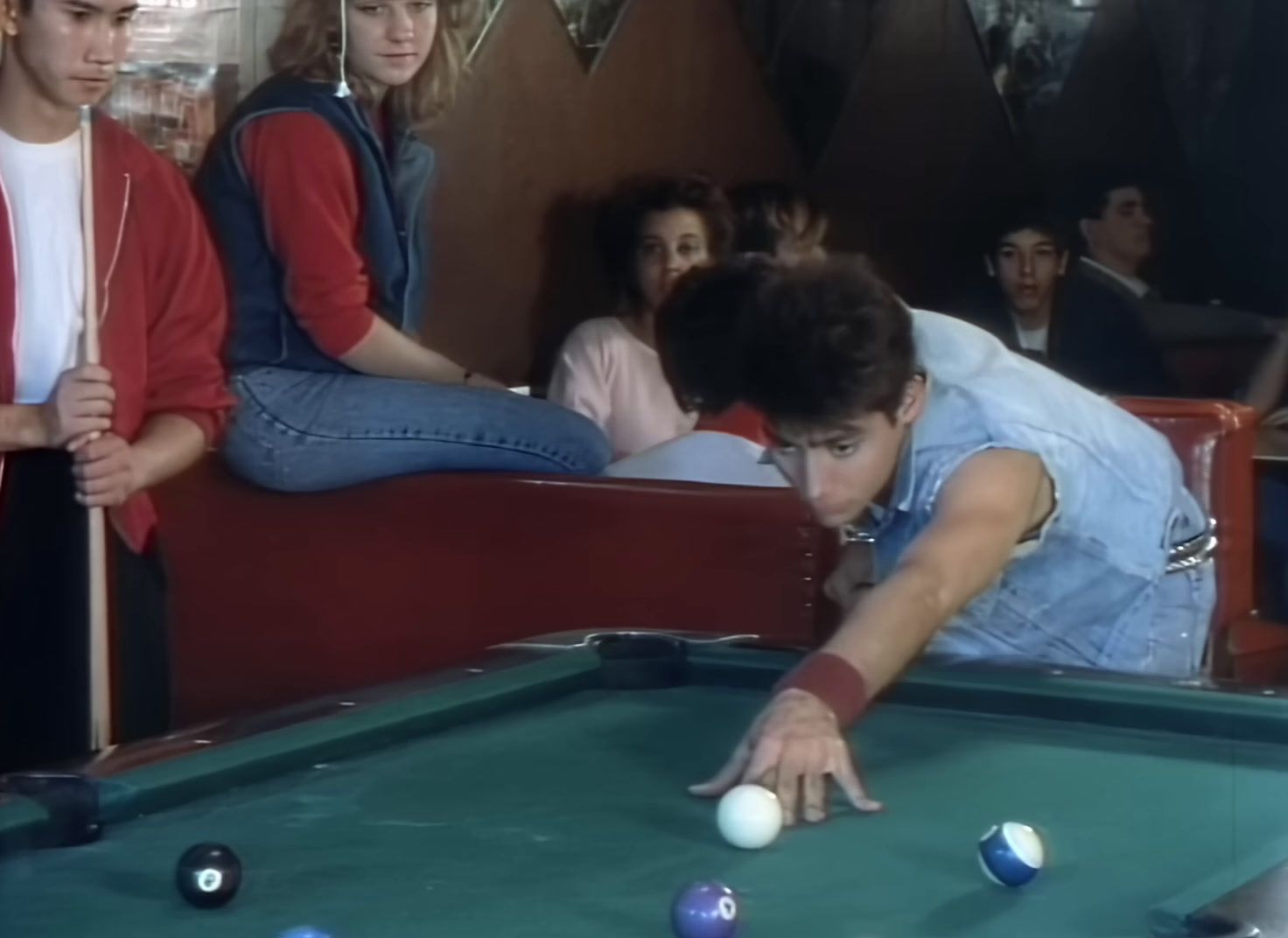 a group of young people playing a game of pool