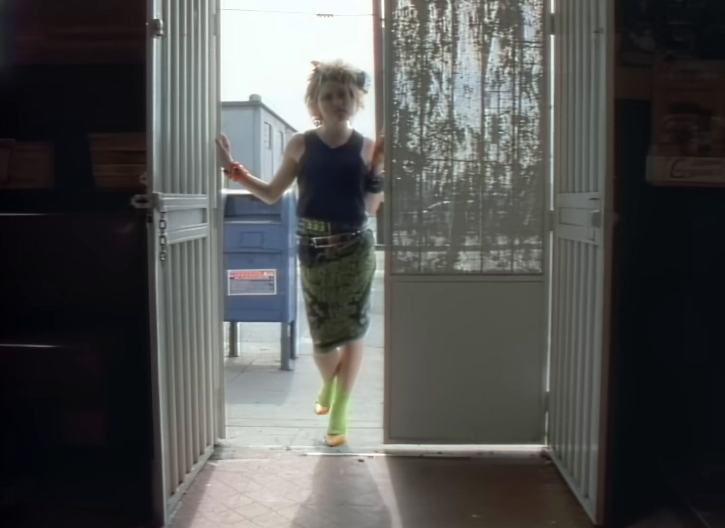 a little girl that is standing in a doorway