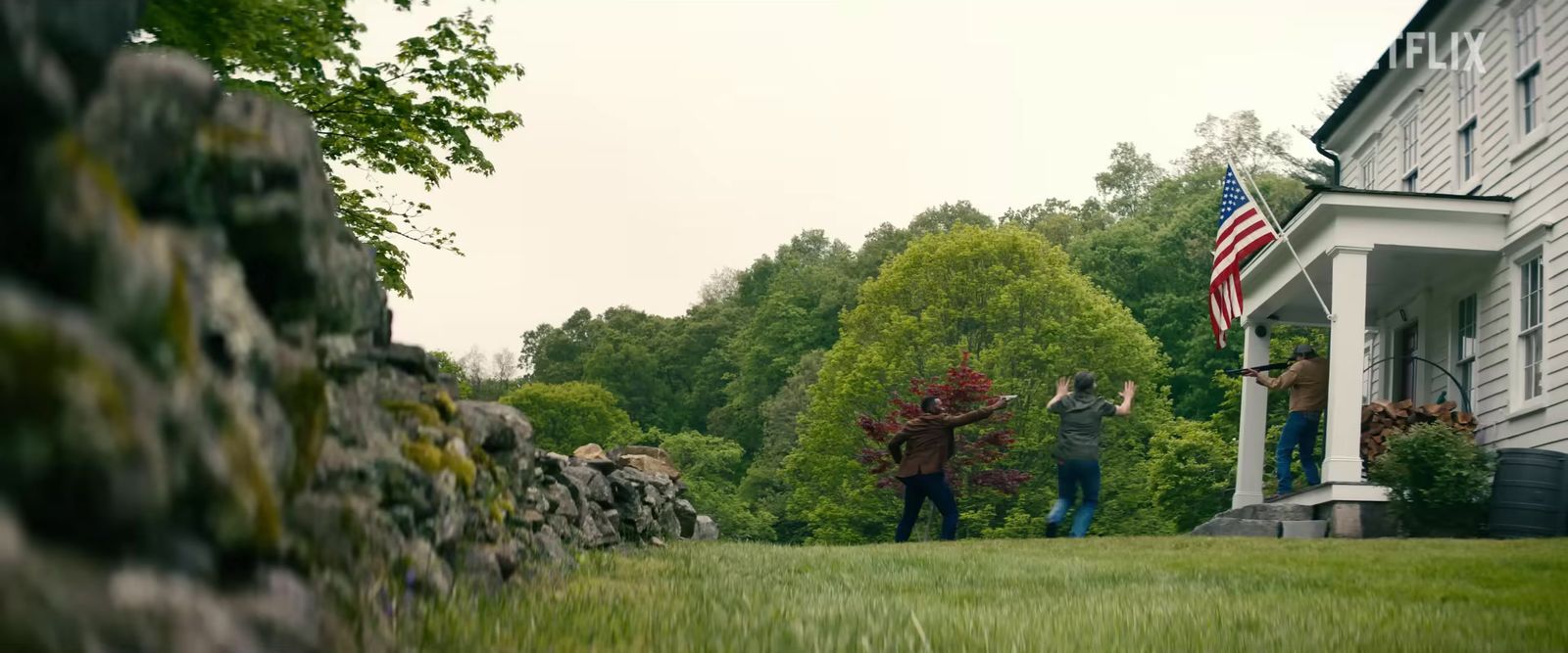 a group of people standing on top of a lush green field