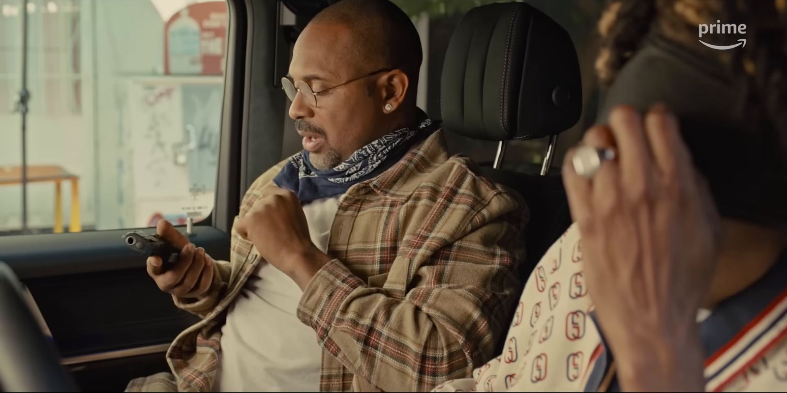 a man sitting in a car holding a remote control