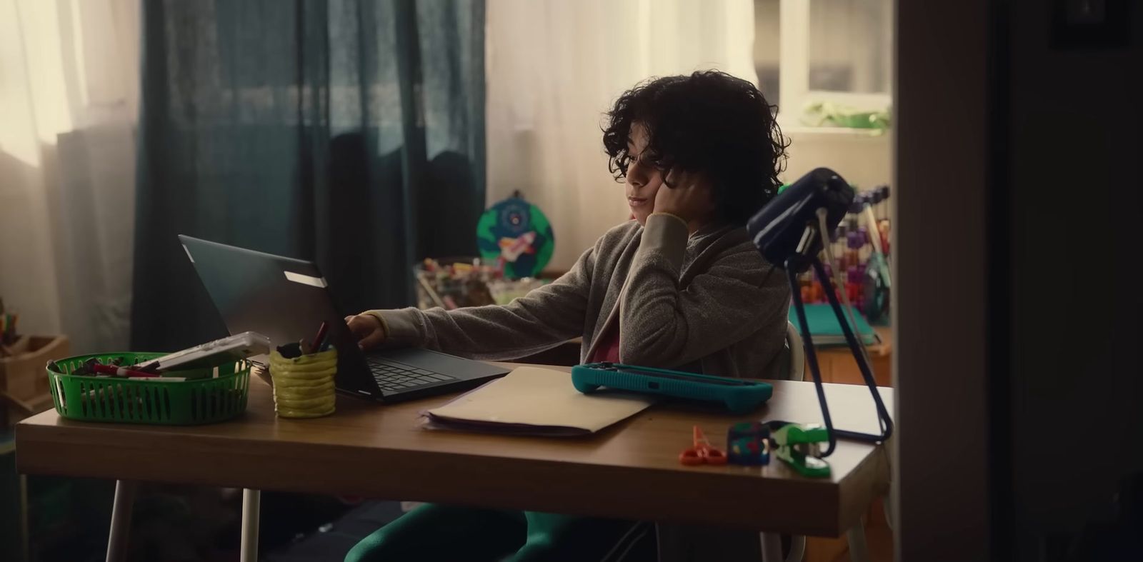 a person sitting at a desk with a laptop